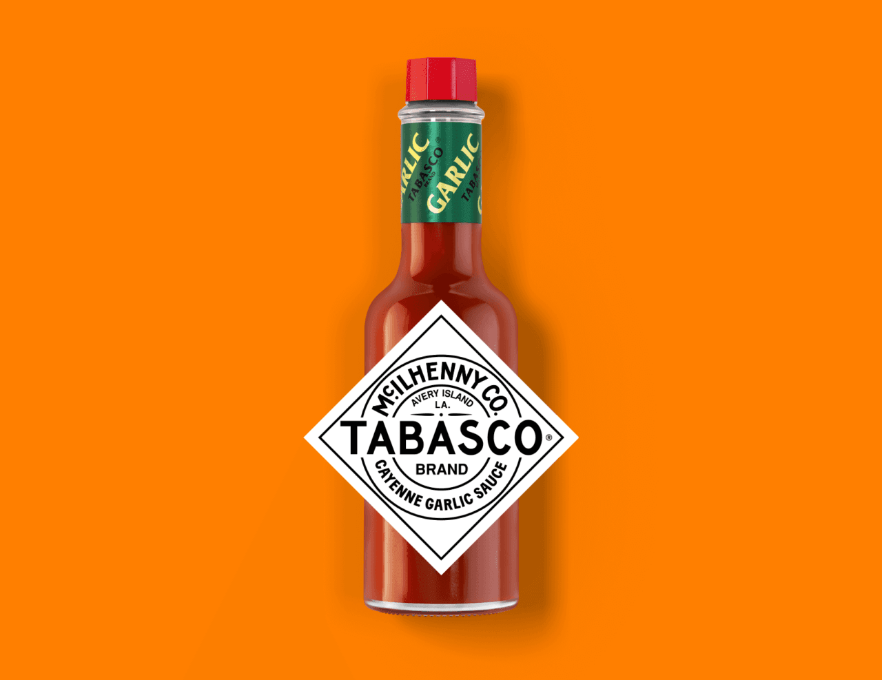 Tabasco Cayenne Garlic sauce bottle on an orange background