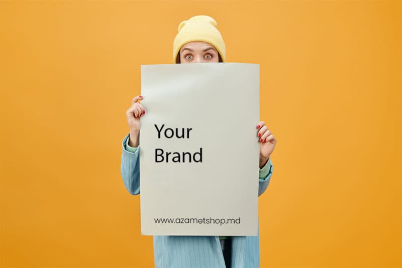Person holding a poster that reads Your Brand